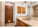 This bathroom features oak cabinets, a tan countertop, a tiled floor, and an exhaust fan at 8606 S Dorsey Ln, Tempe, AZ 85284