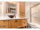 Bathroom featuring granite countertop, vessel sink, wood cabinets and walk-in shower at 8606 S Dorsey Ln, Tempe, AZ 85284