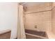 The bathroom features tan tile, a brown bathtub, and a shower with a tan shower curtain at 8606 S Dorsey Ln, Tempe, AZ 85284