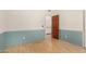 Bedroom features white walls and blue painted accent walls, and a wood door at 8606 S Dorsey Ln, Tempe, AZ 85284