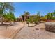 Beautiful custom home featuring desert landscaping, mature cacti, and an ADT security system sign at 8606 S Dorsey Ln, Tempe, AZ 85284