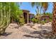 Desert home with an arched entryway, stone facade, tile roof, mature cacti, and professional landscaping at 8606 S Dorsey Ln, Tempe, AZ 85284