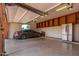 Garage with epoxy floors, stainless steel refrigerator, storage, and a car at 8606 S Dorsey Ln, Tempe, AZ 85284