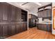 Kitchen with built-in dark wood cabinets, stainless steel appliances, and light countertops at 8606 S Dorsey Ln, Tempe, AZ 85284