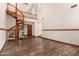 This room features a spiral staircase, wood-look flooring, and high ceilings with a second-floor balcony at 8606 S Dorsey Ln, Tempe, AZ 85284