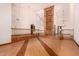 Spacious open-concept living room featuring a soaring ceiling, a large custom bookcase and hardwood floors at 8606 S Dorsey Ln, Tempe, AZ 85284
