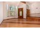 Spacious open-concept living room featuring a soaring ceiling, large windows, and hardwood floors at 8606 S Dorsey Ln, Tempe, AZ 85284