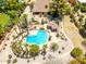 Aerial shot of a uniquely shaped pool with mature landscaping, a small pool house and a built-in fire pit at 8606 S Dorsey Ln, Tempe, AZ 85284