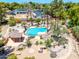 Aerial view of a backyard oasis, showcasing a sparkling blue pool, desert landscaping, and a covered patio at 8606 S Dorsey Ln, Tempe, AZ 85284