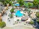 Aerial shot of a uniquely shaped pool with mature landscaping, a small pool house and a built-in fire pit at 8606 S Dorsey Ln, Tempe, AZ 85284