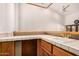 Wet bar area features white tile counters, a sink, and wooden cabinets, offering a convenient space for drinks at 8606 S Dorsey Ln, Tempe, AZ 85284