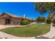 Spacious backyard with lush lawn, mature landscaping, and a sparkling pool, perfect for outdoor living at 8803 N 105Th Dr, Peoria, AZ 85345