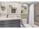 Modern bathroom featuring a gray vanity, white countertop, neutral walls, and stylish shelving and decor at 8803 N 105Th Dr, Peoria, AZ 85345