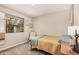 Neutral bedroom featuring a window with natural light, soft carpet, and simple decor at 8803 N 105Th Dr, Peoria, AZ 85345