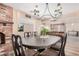 Elegant dining room with a classic table, chandelier, and fireplace, creating an ideal setting for gatherings at 8803 N 105Th Dr, Peoria, AZ 85345