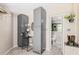 Well-organized dressing area and vanity with stylish gray cabinetry, and access to the en-suite bathroom at 8803 N 105Th Dr, Peoria, AZ 85345