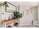 Stylish entryway with decorative table, mirror, plants, and niche shelving for storage and decor at 8803 N 105Th Dr, Peoria, AZ 85345