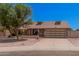 Charming single-story home featuring a brick facade, well-maintained landscaping, and a two-car garage at 8803 N 105Th Dr, Peoria, AZ 85345