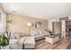 Cozy living room with comfortable seating, wood-style flooring, and a fireplace, creating a warm and inviting atmosphere at 8803 N 105Th Dr, Peoria, AZ 85345
