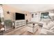 Comfortable living room with ample seating, a large TV, and stylish decor creating a relaxing and inviting space at 8803 N 105Th Dr, Peoria, AZ 85345
