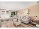 Inviting living room featuring a plush sofa, ample natural light, and stylish decor, perfect for relaxation and comfort at 8803 N 105Th Dr, Peoria, AZ 85345