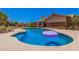 Inviting backyard featuring a private pool, lush lawn, and serene patio area perfect for relaxation and entertaining at 8803 N 105Th Dr, Peoria, AZ 85345