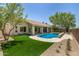 Inviting backyard with a pool, artificial turf, and serene landscaping for outdoor enjoyment at 9112 E Palm Tree Dr, Scottsdale, AZ 85255
