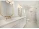 Elegant bathroom featuring dual sinks, gold accents, and a modern glass-enclosed shower at 9112 E Palm Tree Dr, Scottsdale, AZ 85255