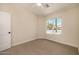Cozy bedroom with neutral tones, featuring a large window and plush carpeting at 9112 E Palm Tree Dr, Scottsdale, AZ 85255