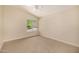 Bright and airy bedroom with a view of the front yard, carpet floor, and neutral color palette at 9112 E Palm Tree Dr, Scottsdale, AZ 85255