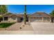 Charming single-story home featuring desert landscaping, a three car garage, and a tile roof at 9112 E Palm Tree Dr, Scottsdale, AZ 85255