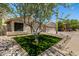 Inviting single-story home with a well-maintained yard, desert landscaping, and a three-car garage at 9112 E Palm Tree Dr, Scottsdale, AZ 85255