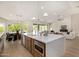 Kitchen island with quartz countertops, brass hardware, and seating at 9112 E Palm Tree Dr, Scottsdale, AZ 85255