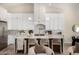 Bright kitchen featuring white cabinets, a large center island with seating, and modern pendant lighting at 9112 E Palm Tree Dr, Scottsdale, AZ 85255