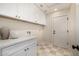 Functional laundry room with ample cabinet space and modern appliances at 9112 E Palm Tree Dr, Scottsdale, AZ 85255