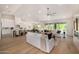 Large open concept living room seamlessly integrating the kitchen, living, and dining areas and a backyard view at 9112 E Palm Tree Dr, Scottsdale, AZ 85255