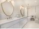 Elegant main bathroom with dual vanities, freestanding tub, decorative mirrors, and chandelier at 9112 E Palm Tree Dr, Scottsdale, AZ 85255