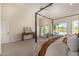 Bright main bedroom with pool view and access featuring neutral decor and plenty of natural light at 9112 E Palm Tree Dr, Scottsdale, AZ 85255