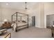 Spacious main bedroom featuring a canopy bed, ensuite bathroom, and neutral tones at 9112 E Palm Tree Dr, Scottsdale, AZ 85255
