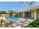Relaxing backyard featuring a sparkling pool, tiled patio, and seamless indoor-outdoor living at 9112 E Palm Tree Dr, Scottsdale, AZ 85255