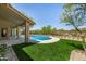 Beautiful backyard with a sparkling pool, lush greenery, and a well-manicured lawn at 9112 E Palm Tree Dr, Scottsdale, AZ 85255
