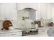 Beautiful backsplash detail behind the stove top with pot filler faucet at 9112 E Palm Tree Dr, Scottsdale, AZ 85255