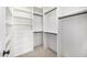 Well-organized walk-in closet with custom shelves, drawers, and hanging rods for optimal storage at 9112 E Palm Tree Dr, Scottsdale, AZ 85255