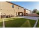 Spacious backyard featuring artificial grass, brick pavers, and string lights at 9350 W Williams St, Tolleson, AZ 85353