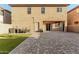 Spacious backyard featuring artificial grass, brick pavers, and string lights at 9350 W Williams St, Tolleson, AZ 85353