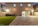 Spacious backyard featuring artificial grass, brick pavers, and string lights at 9350 W Williams St, Tolleson, AZ 85353