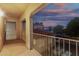 A covered balcony overlooking neighboring rooftops against a dusk sky at 9350 W Williams St, Tolleson, AZ 85353
