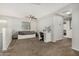 Bright bedroom with a ceiling fan, carpet floors, a bed with drawers and vanity area at 9350 W Williams St, Tolleson, AZ 85353