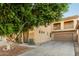 Attractive home featuring a two-car garage, a balcony, and mature landscaping at 9350 W Williams St, Tolleson, AZ 85353