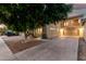Attractive home featuring a two-car garage, a balcony, and mature landscaping at 9350 W Williams St, Tolleson, AZ 85353
